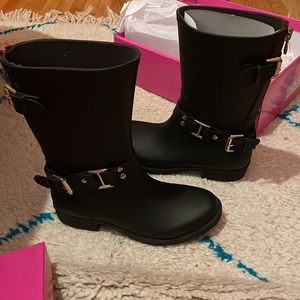 Black & Red Brand new rain boots with red embellishment at back of boot.